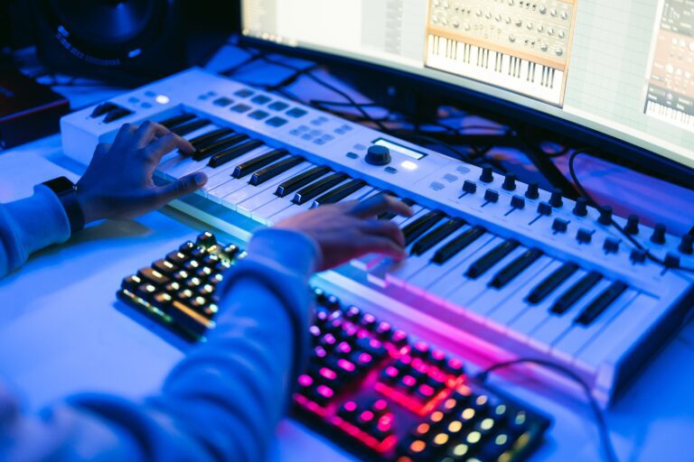 Sound producer working in a technological modern studio with lights on dark background